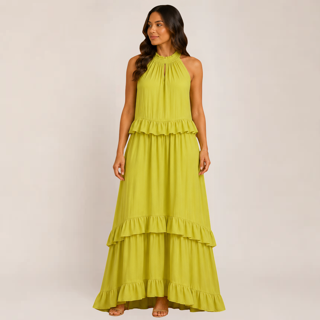 Female model wearing a tiered vacation dress against a plain background.
