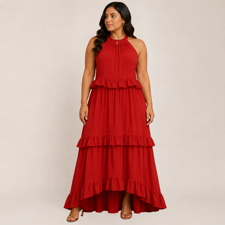 Female model wearing a tiered ruffle maxi dress on a plain background.
