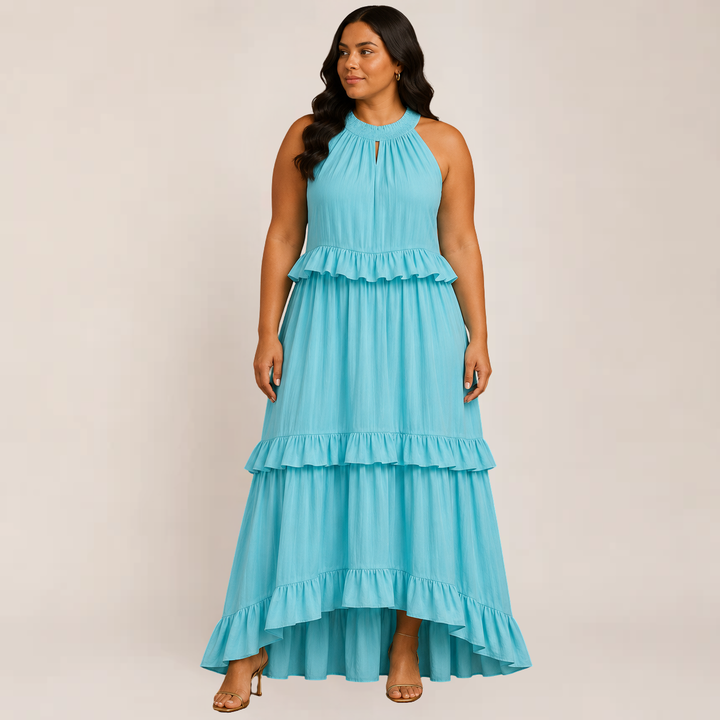 Model wearing a layered ruffle summer dress on a plain background.