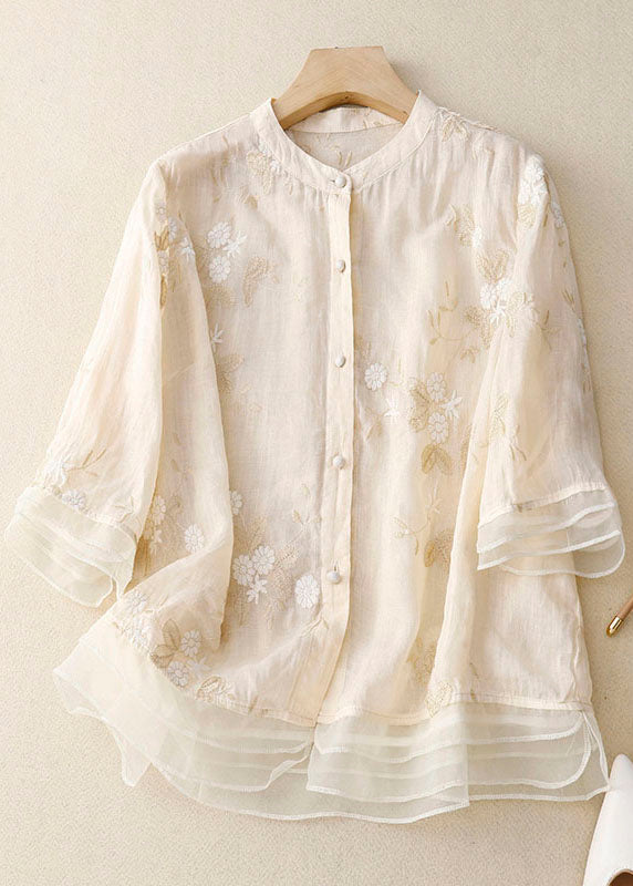 A lightweight blouse with detailed floral embroidery.