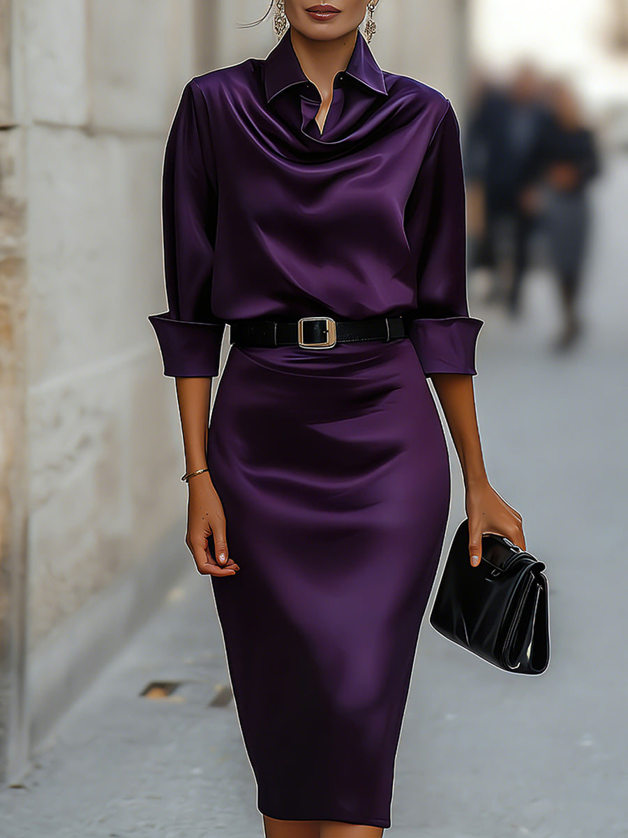 Female model in a navy midi dress with shirt-style neckline on a plain background.