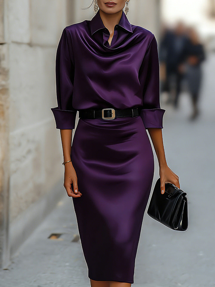  Female wearing a formal midi dress with a flattering waist detail on a plain background.