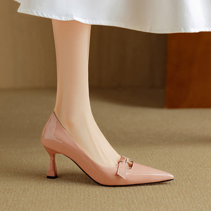 Feminine blush kitten heel pump with glossy finish on a plain background.