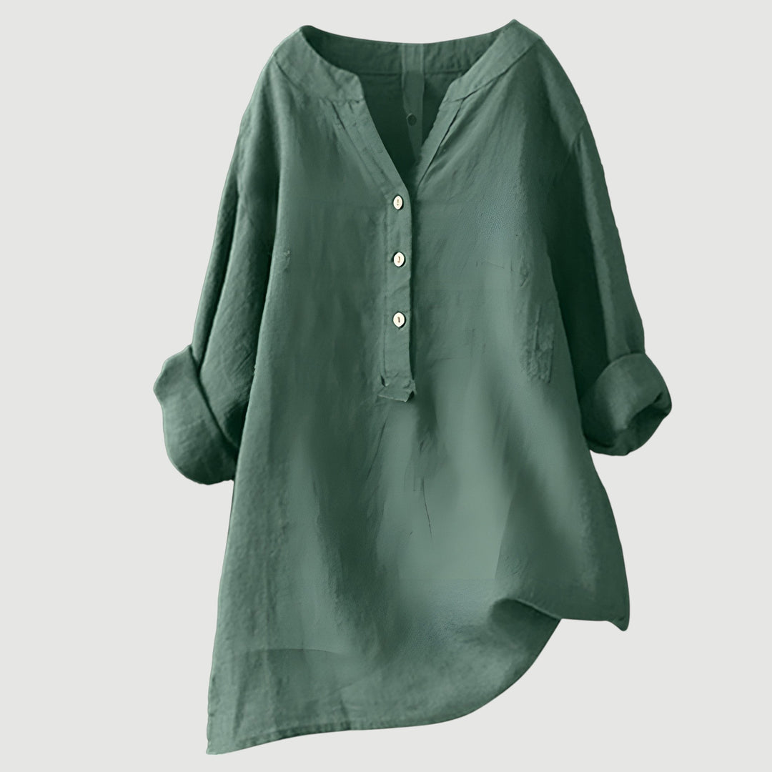 Relaxed linen top on a plain background.
