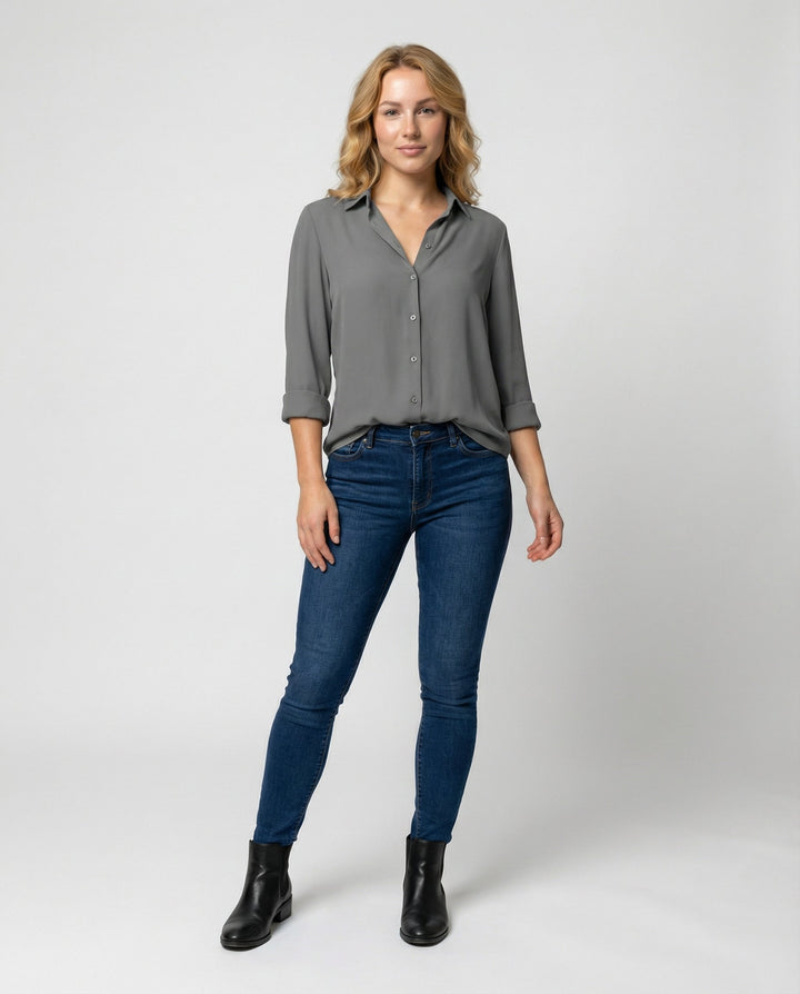 Female modelling a relaxed fit blouse with button front detail.