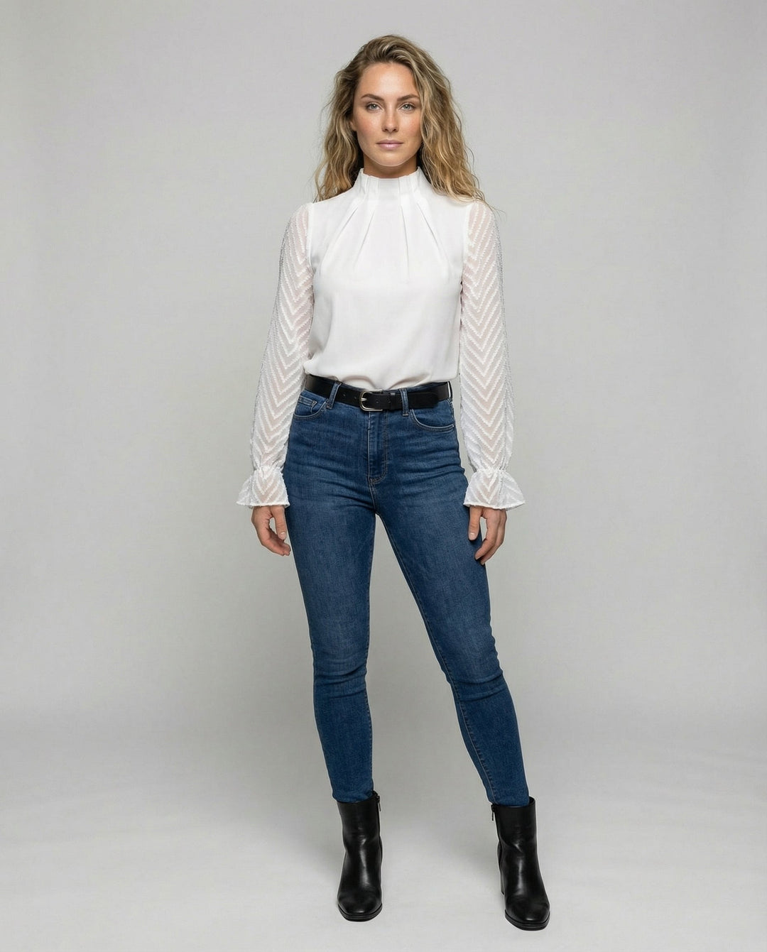Female modelling a timeless long-sleeved top with a flattering fit.