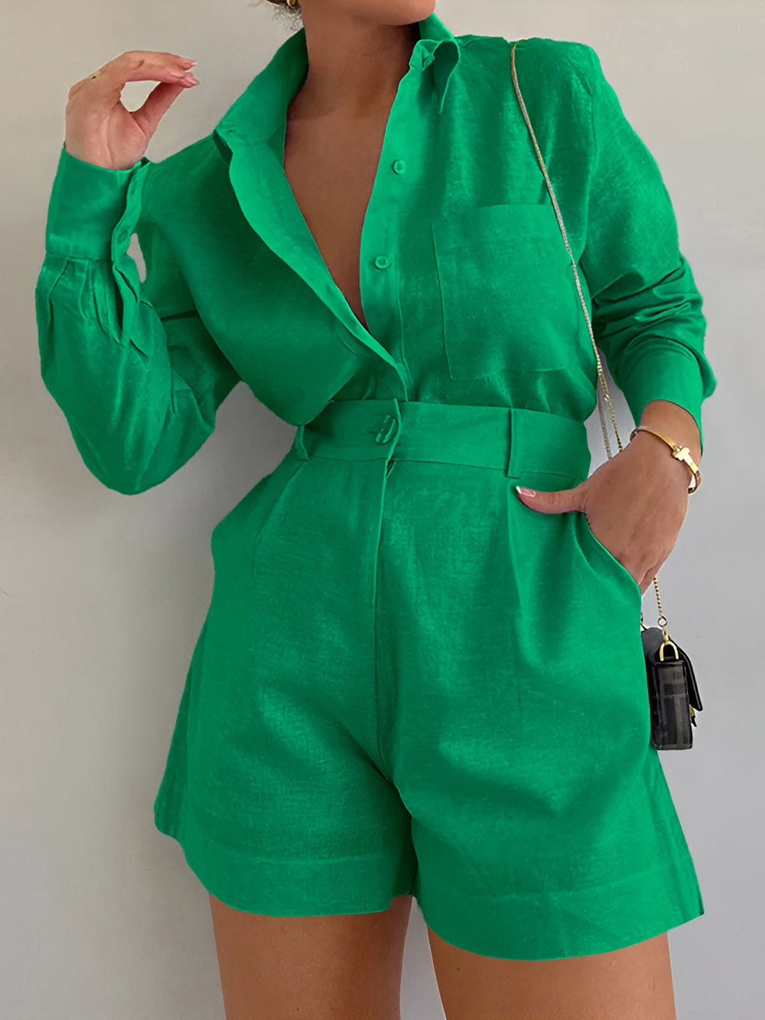 Female model in a long sleeve resort style outfit on a plain background.
