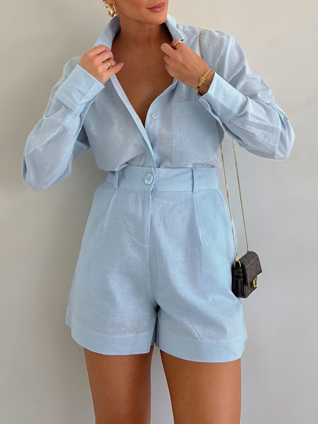 Female model in a relaxed two piece outfit on a plain background.