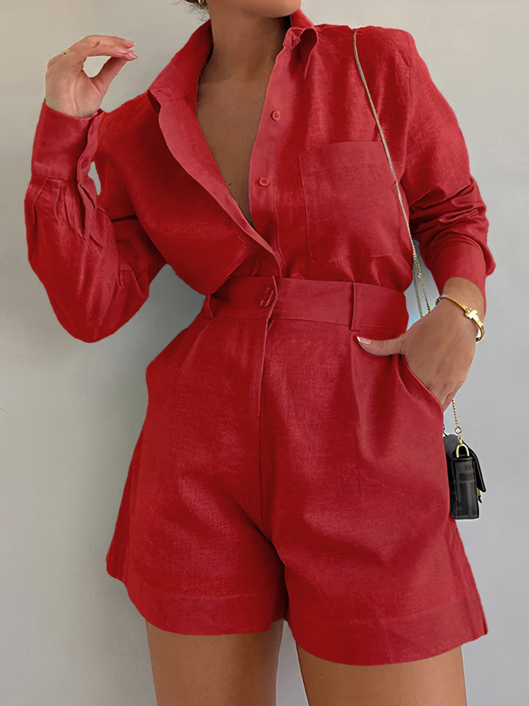 Woman wearing a relaxed matching top and pants set on a plain background.