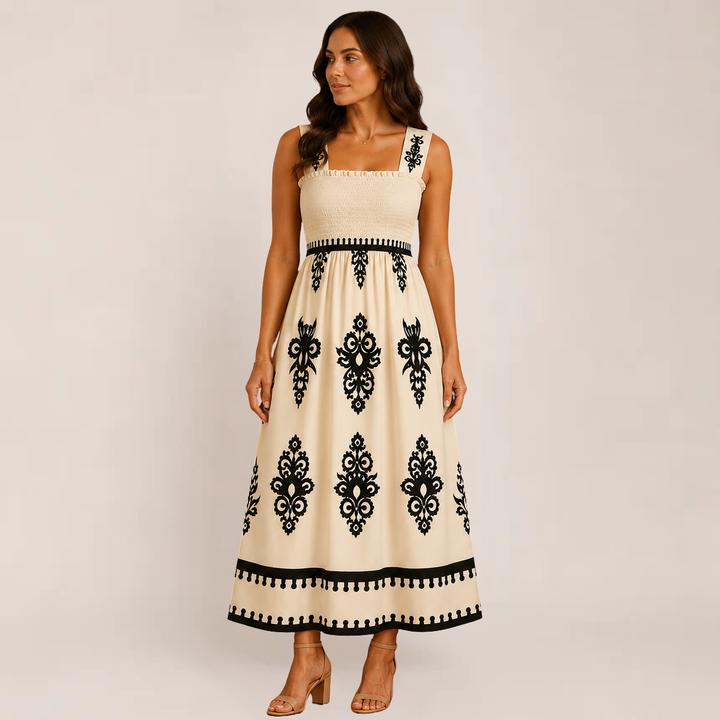 Female wearing a flowy sleeveless maxi dress on a plain background.