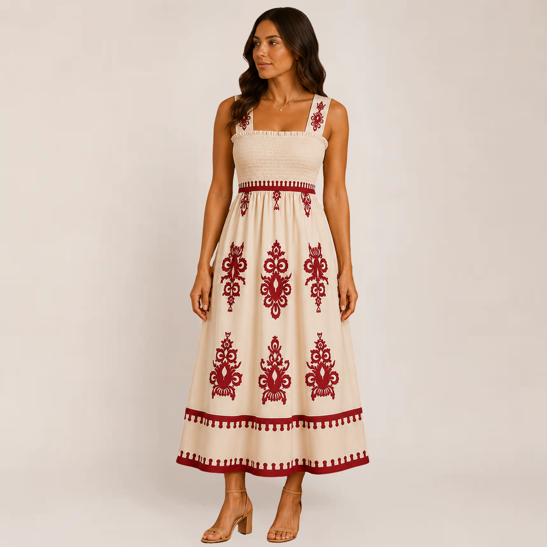 Model in a flowy ankle-length sleeveless dress on a plain background.