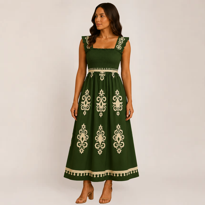 Woman posing in a lightweight maxi dress with soft drape on a plain backdrop