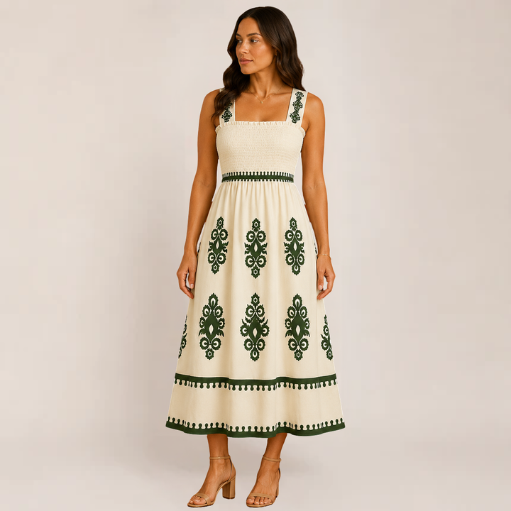 Woman wearing an elegant sleeveless maxi outfit on a plain background.