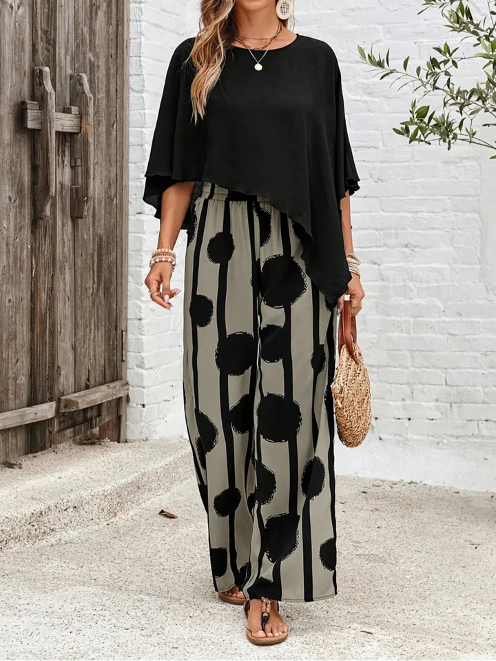 Woman wearing a chic printed trouser set with a modern asymmetric top.