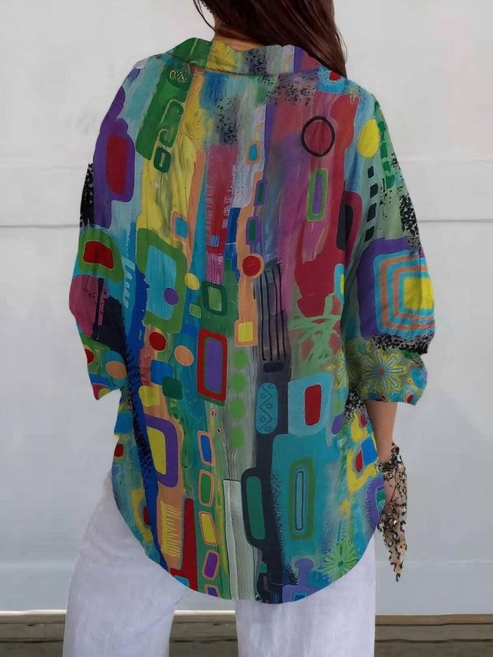 Woman wearing a polished long sleeve blouse on a plain background.