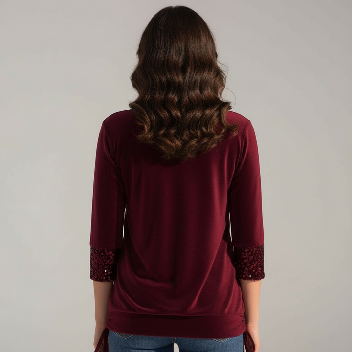 Woman modelling a sequined blouse styled for casual and occasion wear.