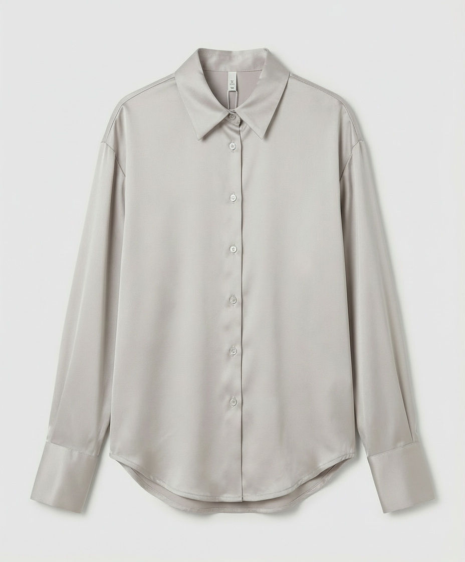 Vintage-inspired silk blouse with refined detailing.