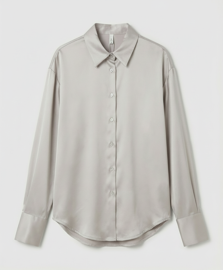 Vintage-inspired silk blouse with refined detailing.