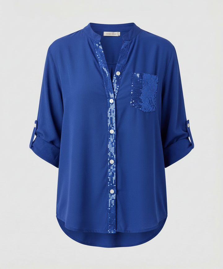 Casual blouse with sparkling pocket accent.