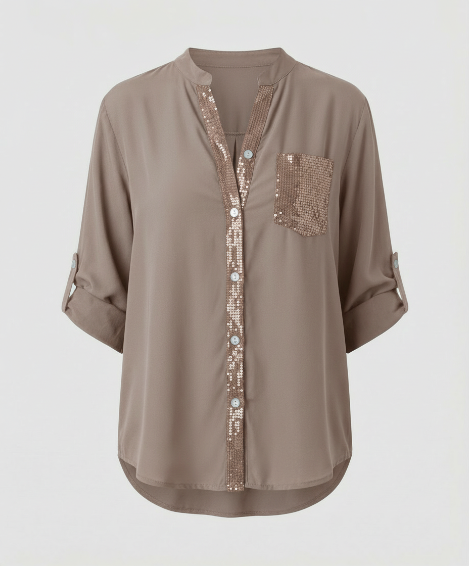 Glitter blouse with roll-up sleeves against a plain background.