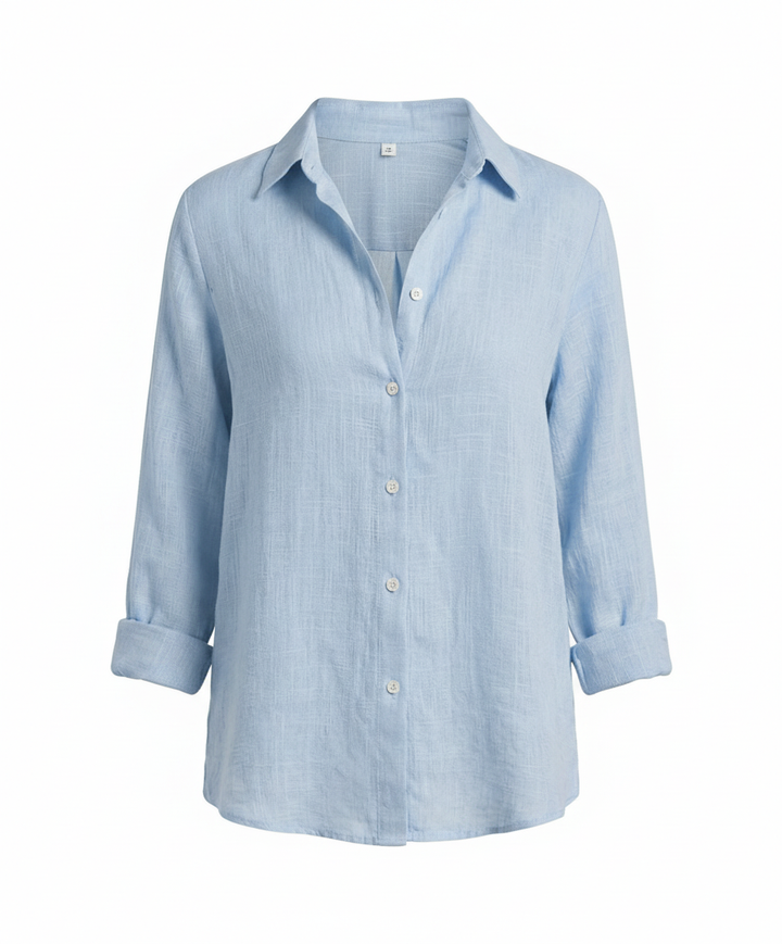 Woman modelling a stylish blouse suitable for office wear.