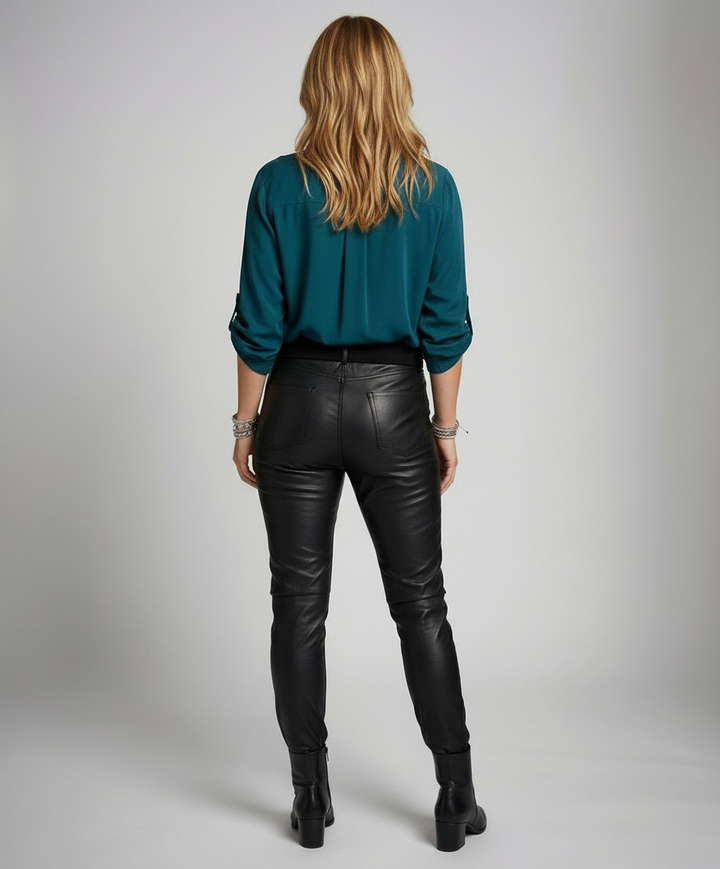 Woman in a lightweight shimmer blouse with sequined pocket detail.