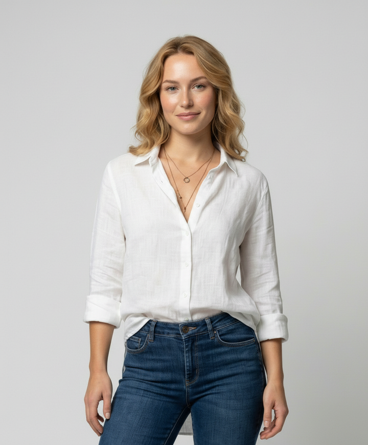 Woman wearing a V-neck blouse against a plain background.