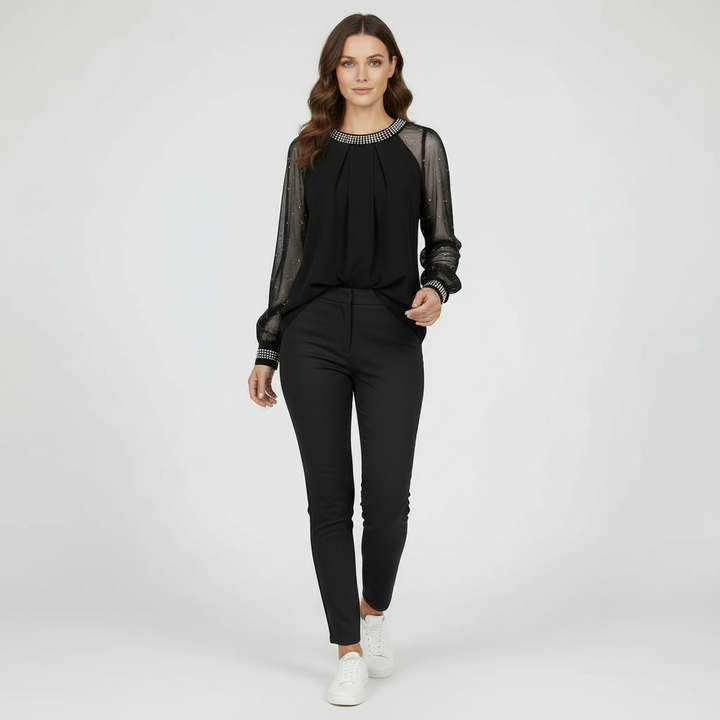 Female modelling a round-neck mesh top with subtle sequin detail.