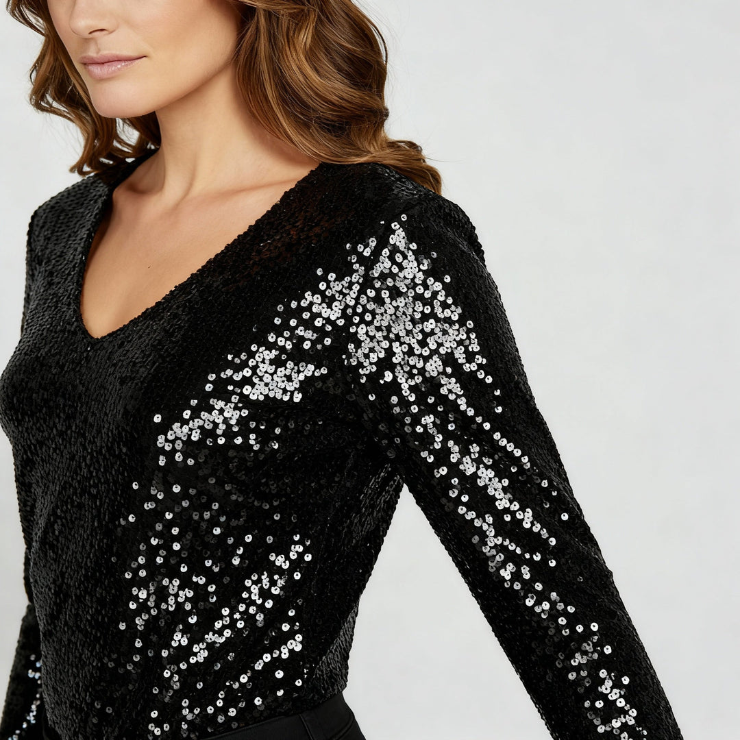 Woman modelling a glittery top styled for evening occasions.