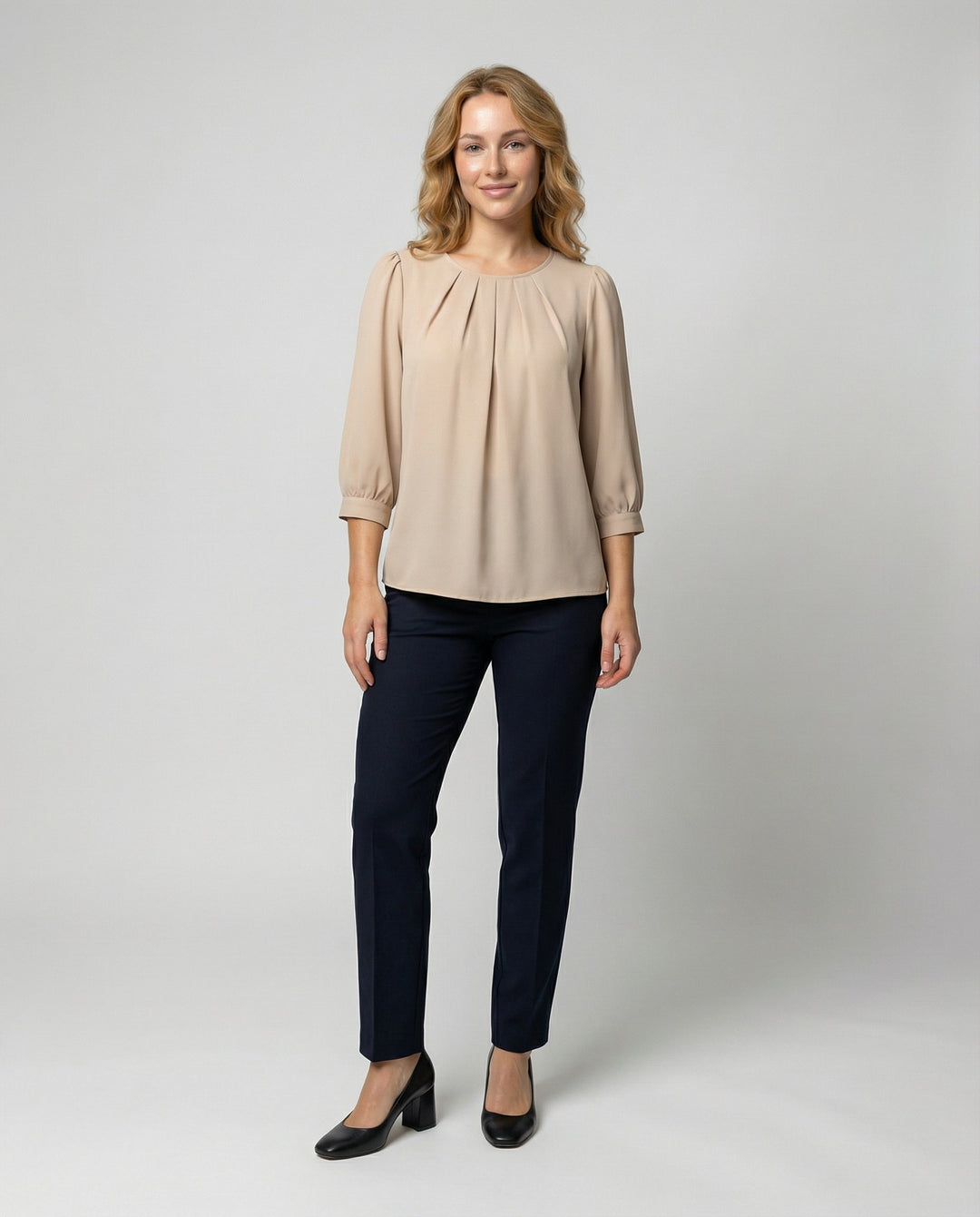Female modelling a soft satin blouse with a relaxed elegant silhouette.