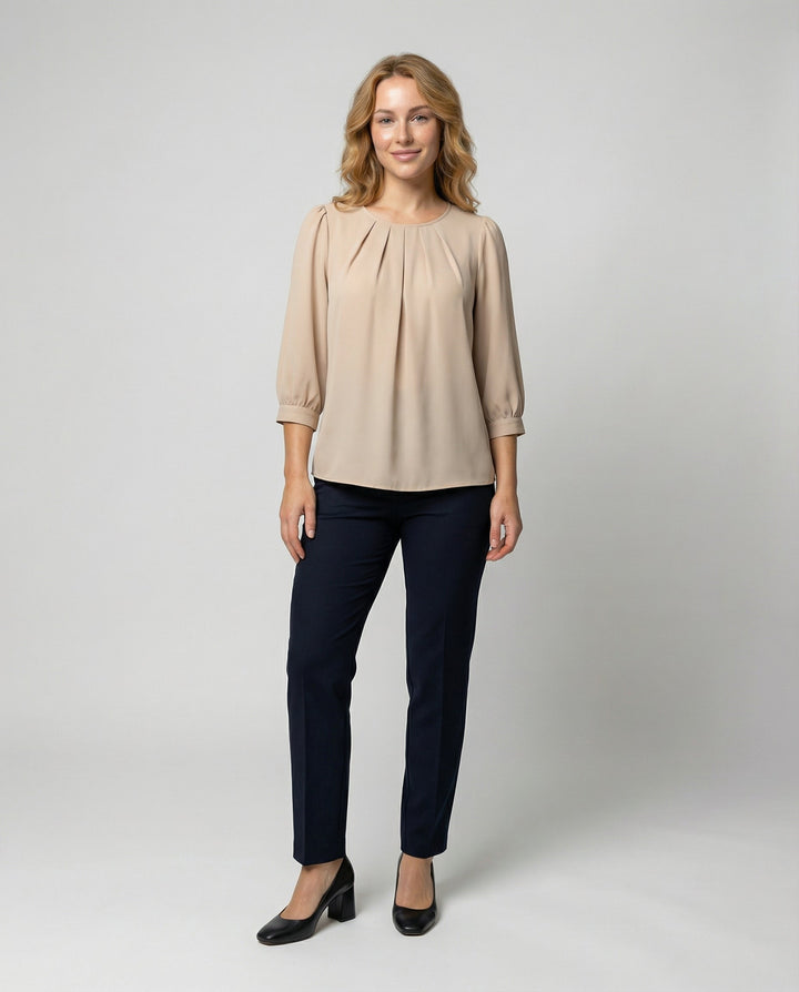 Female modelling a soft satin blouse with a relaxed elegant silhouette.