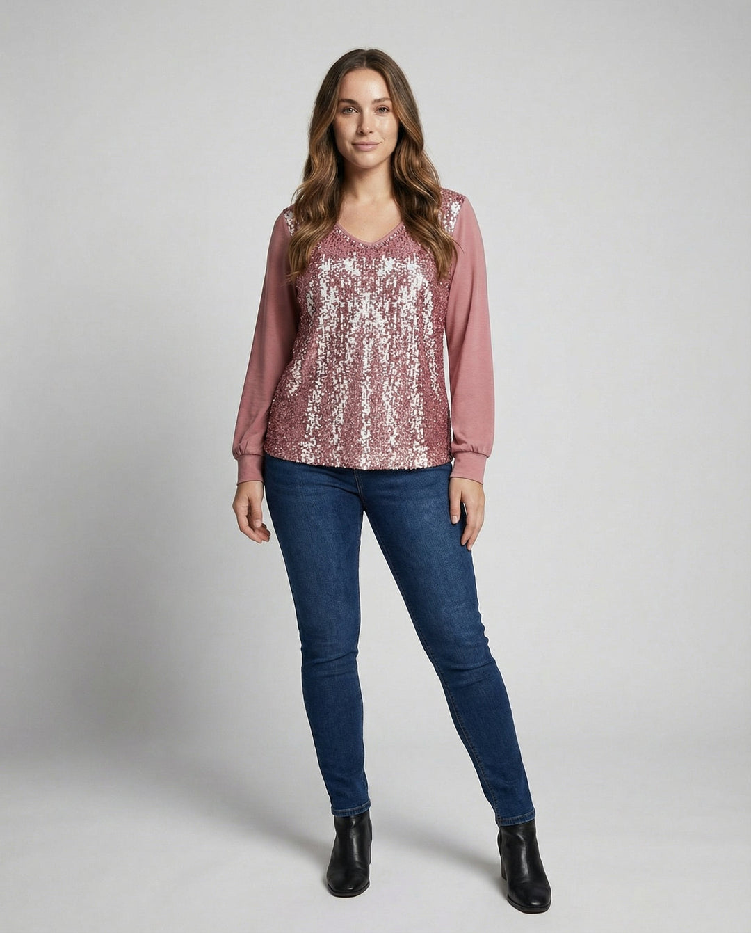 Female modelling a V-neck glitter blouse with elegant shimmer accents.