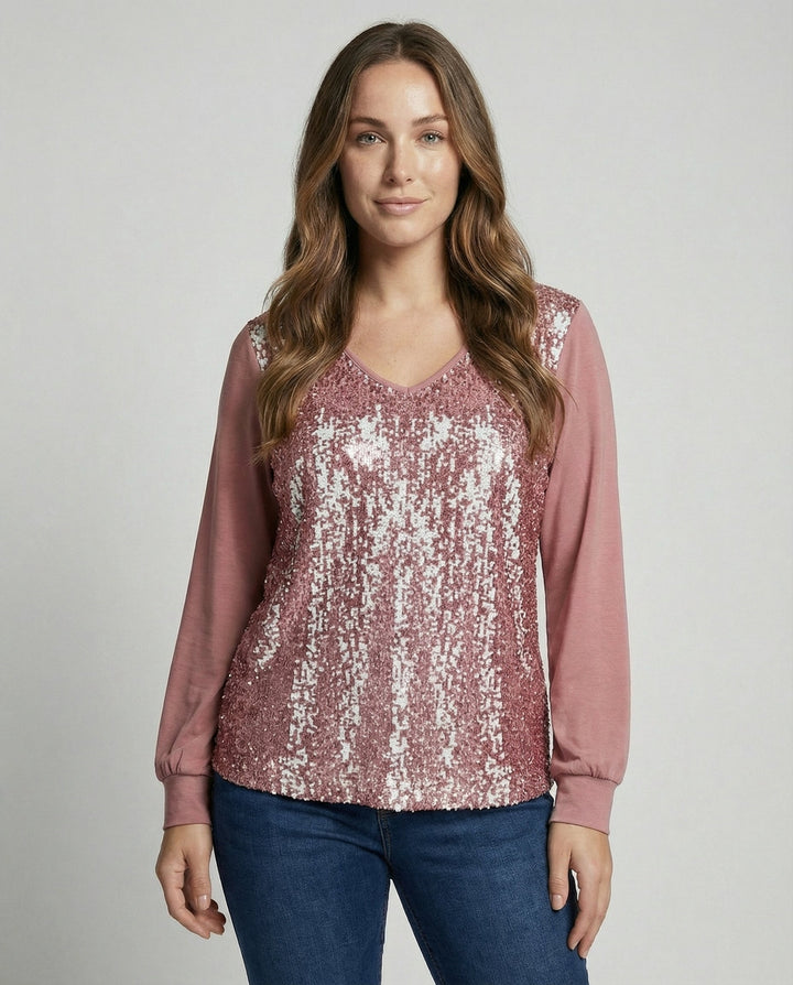 Glitter blouse with subtle sequin details against a plain background.