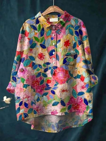A lightweight floral blouse with an elegant drape on a plain background.