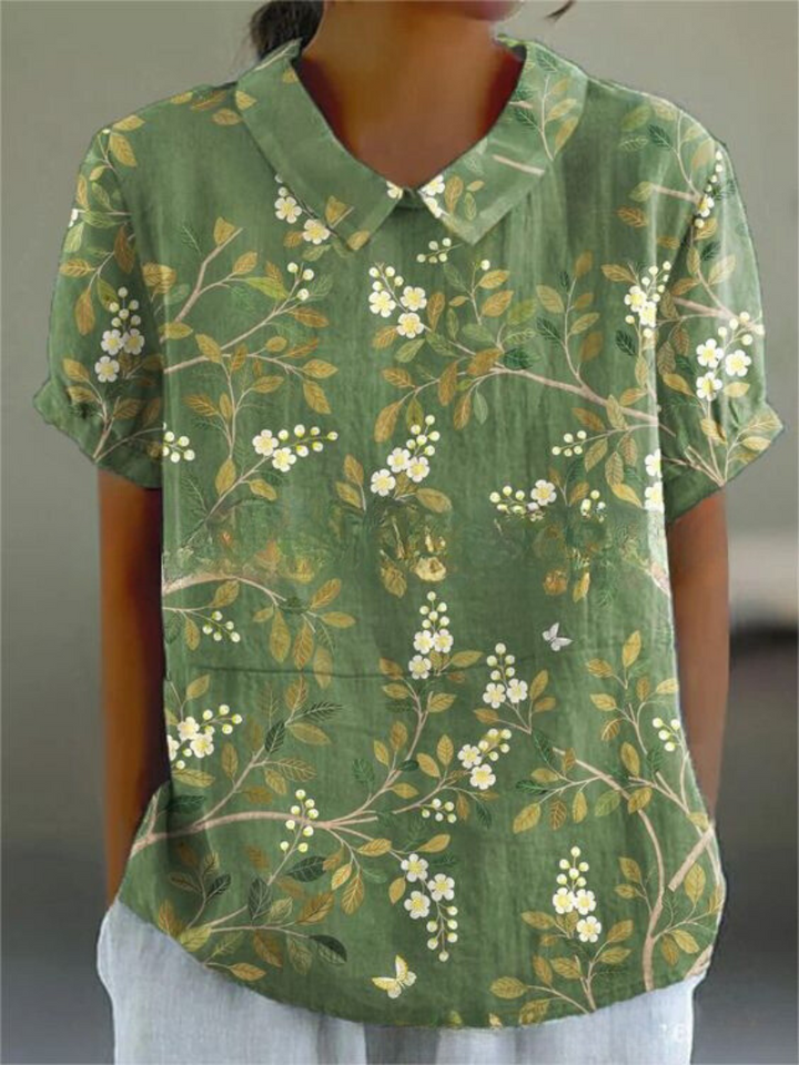  Female wearing a relaxed floral top with a button-front design.