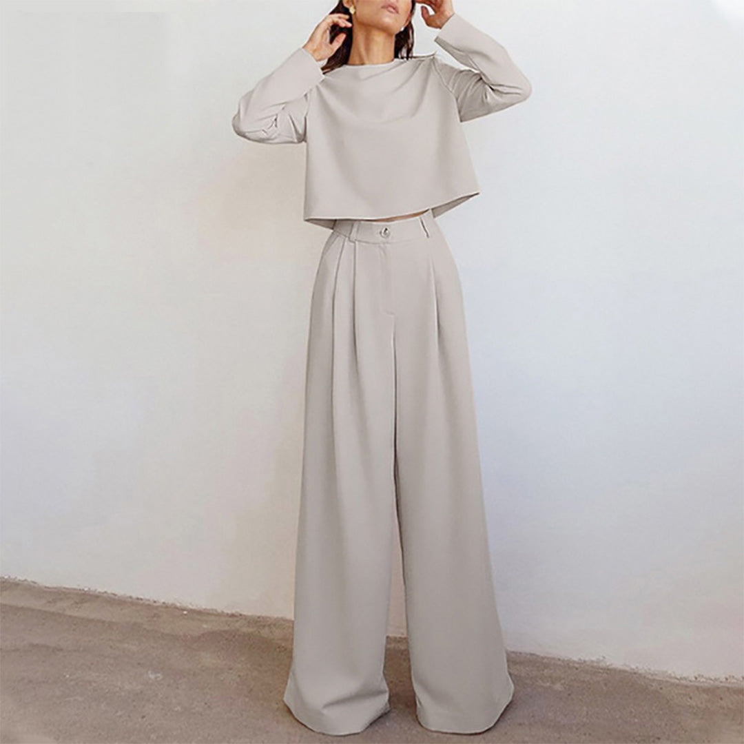 Female wearing a coordinated outfit with a fitted top and cropped trousers.