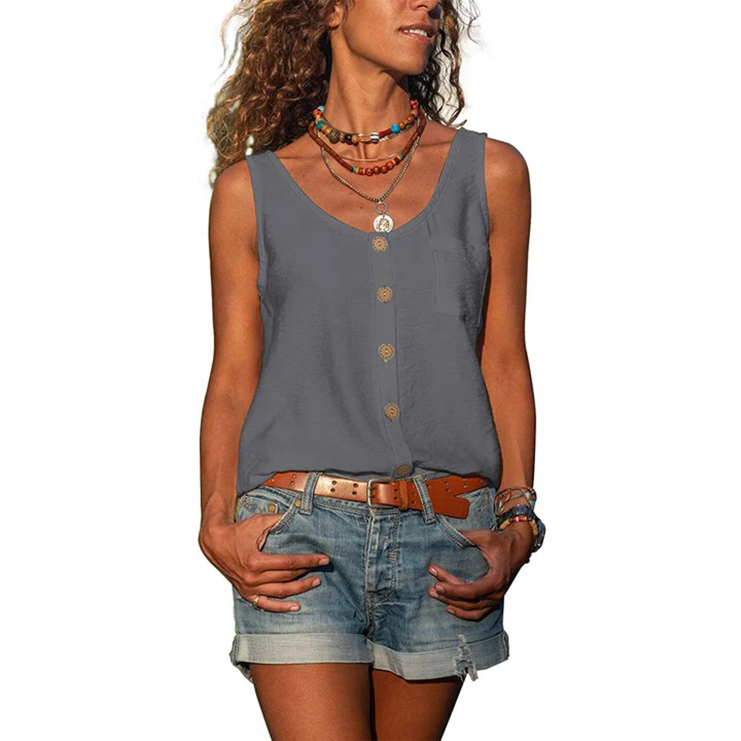 Woman wearing a sleeveless loose fit top against a plain background.
