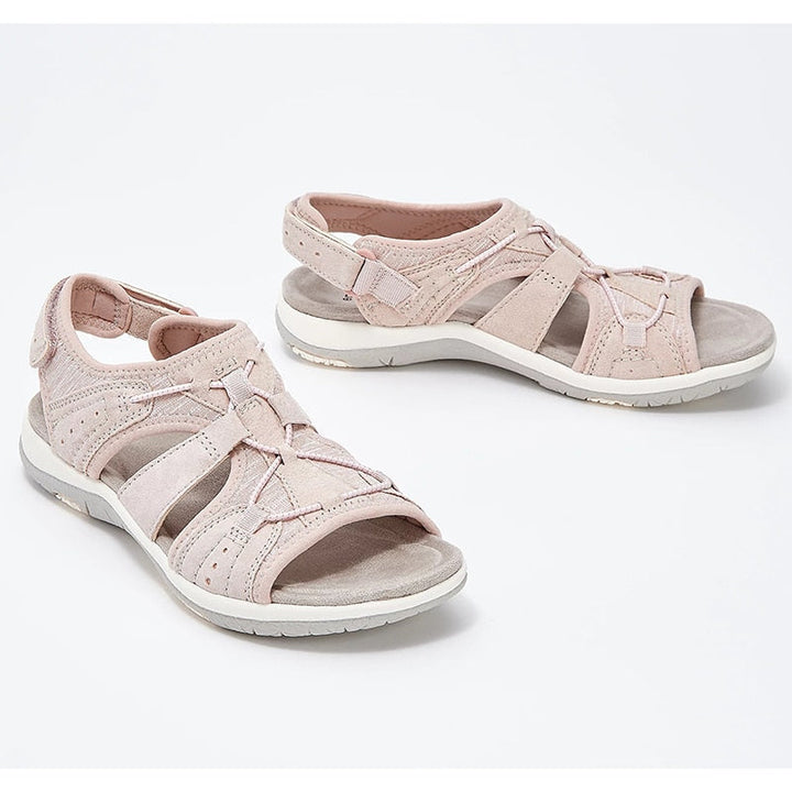 Strappy open-toe sandals for spring outfits on a plain background.