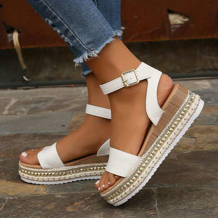 Model showing summer sandals with wide front strap on a plain background.