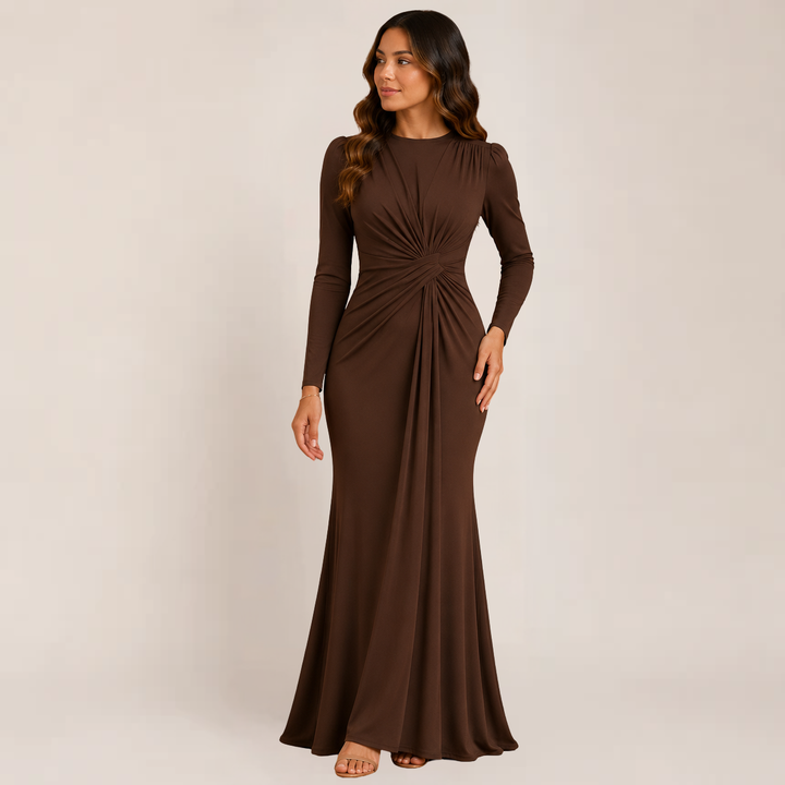 Model showcasing a ruched cocktail dress with a sleek silhouette on a plain background.