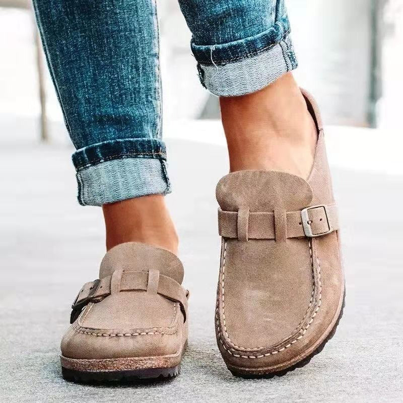 Female showcasing textured sole loafers paired with casual styling on a plain background.