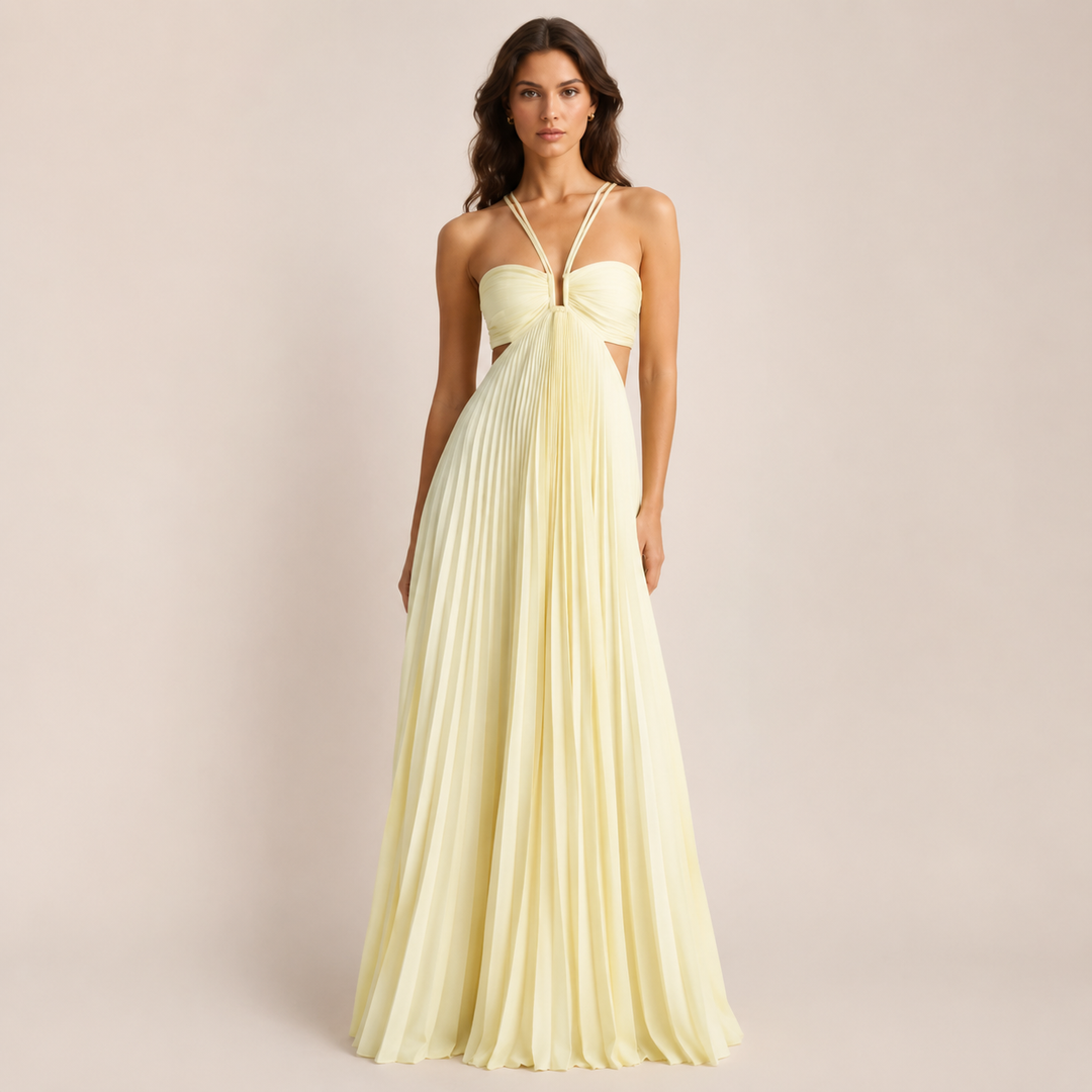 Female model wearing a light yellow A-line floor length dress with spaghetti straps on a plain background.