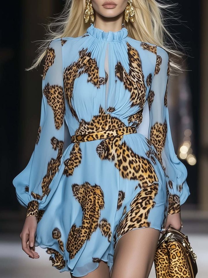 Female model wearing a sky blue leopard print mini dress on a plain background.