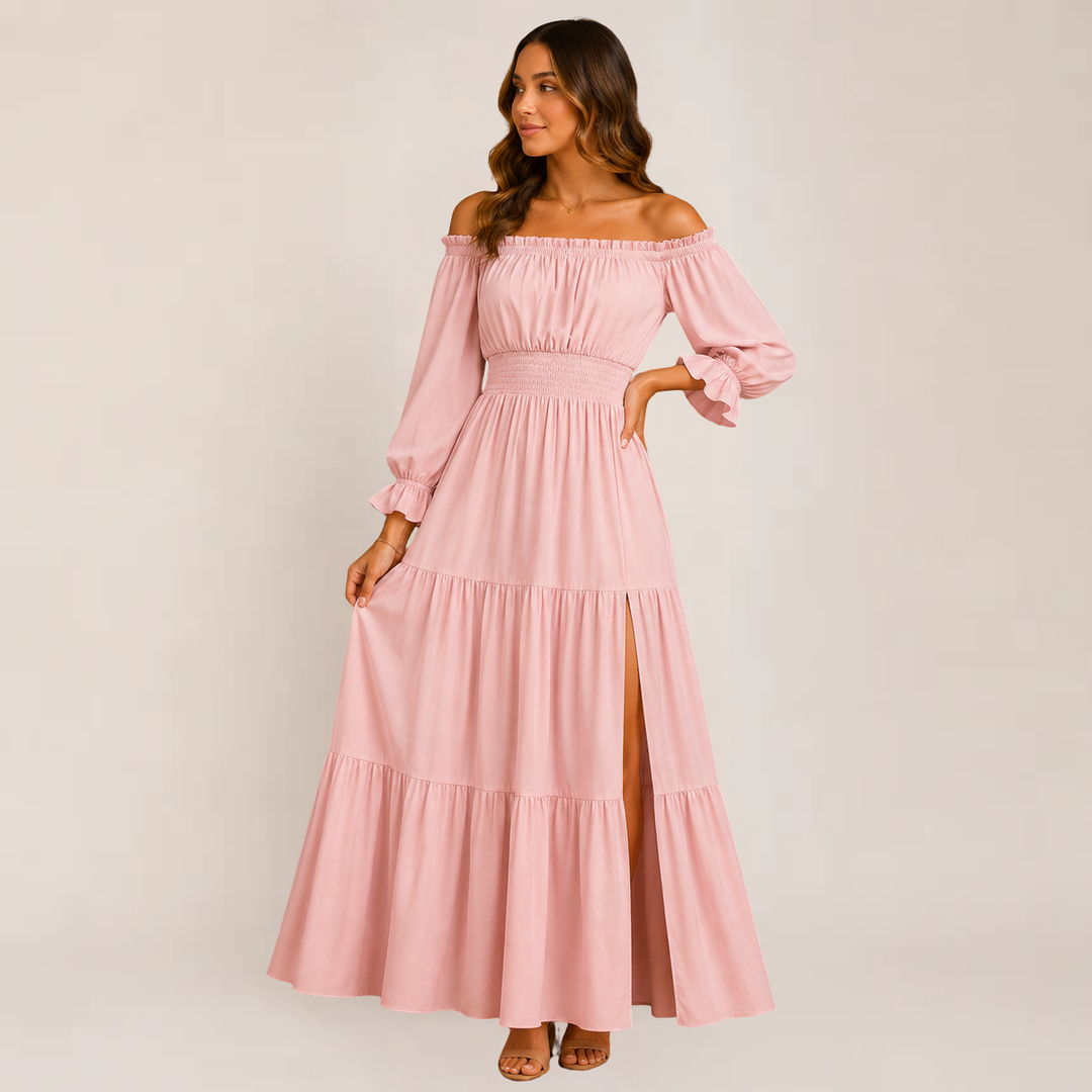 Female wearing an off-shoulder tiered summer dress on a plain background.