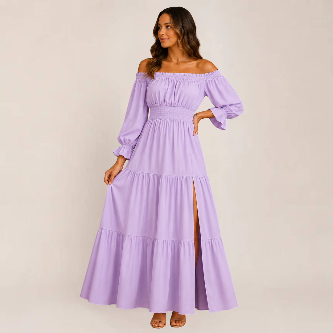 Woman wearing a breezy tiered dress with an elegant off-shoulder style on a plain background.