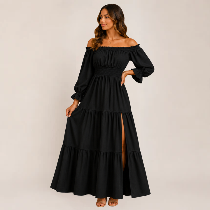 Model showcasing a lightweight tiered midi dress with an off-shoulder neckline on a plain background.