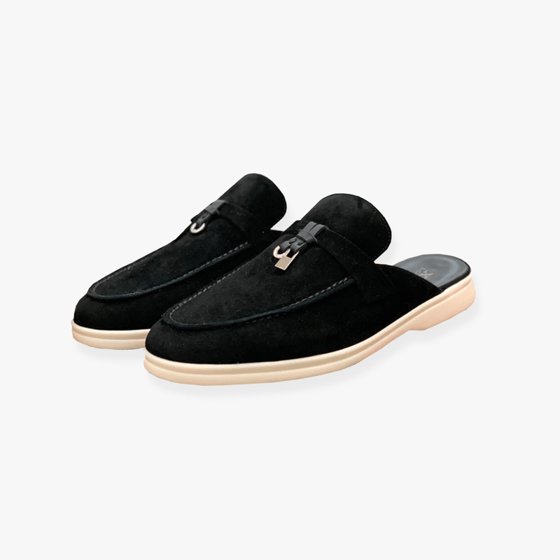 Clean-lined mule shoes on a plain backdrop.