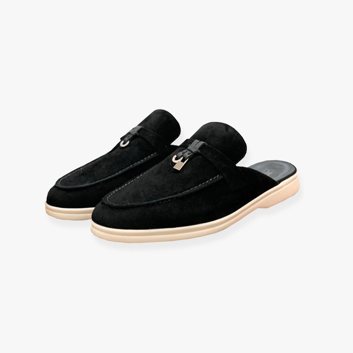 Clean-lined mule shoes on a plain backdrop.