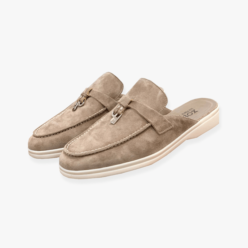 Slip-on mule shoes against a plain background.