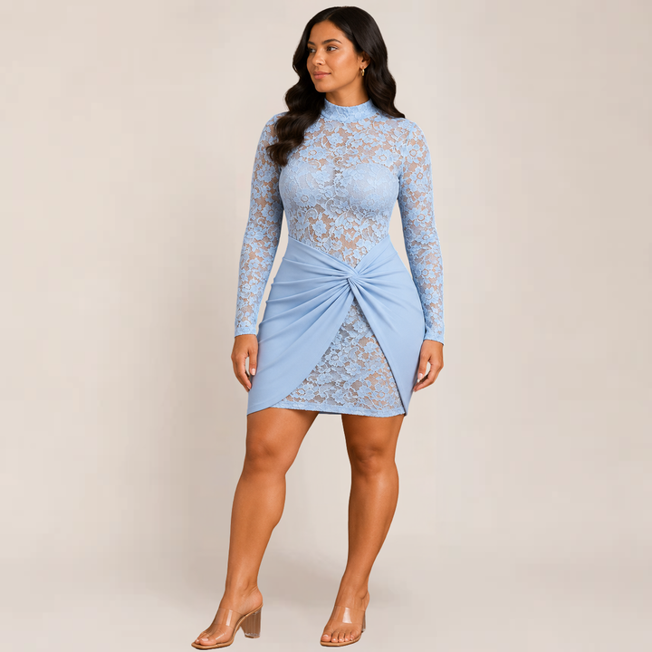 Woman wearing a fitted formal dress with lace sleeves on a plain background.